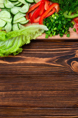 Fresh sliced vegetables on a salad: radish, cherry, greens, cucumber, red pepper. Space for text or design