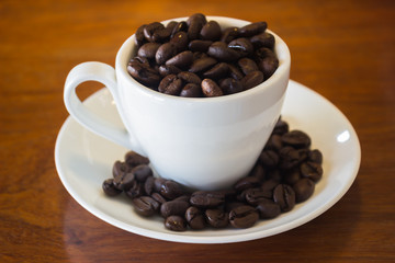 Coffee Cup or Coffee Beans on wooden table