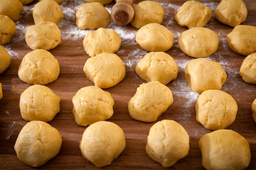 A close-up of the process of cooking buns or pancakes on a wooden table