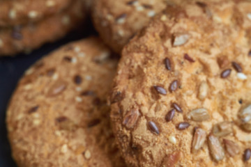 closeup oat large biscuits with sesame, flax and sunflower seeds. Macro