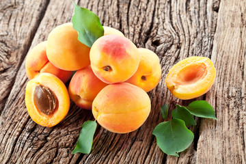 Naklejka na ściany i meble Ripe apricots on the wooden background.