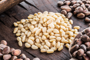 Pine nuts on the wooden table. Organic food. Top view.