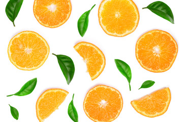 Slices of orange or tangerine decorated with green leaves isolated on white background, top view. Fruit composition