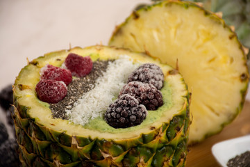 Green smoothie in pineapple