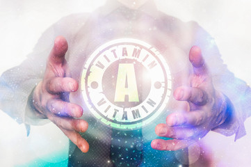 Man is showing vitamin A symbol between his hands