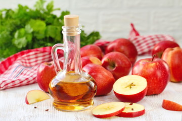 Apple vinegar. Bottle of apple vinegar on wooden background.
