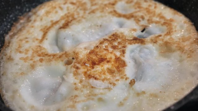 Small pan with Omelette in it, ready to serve.