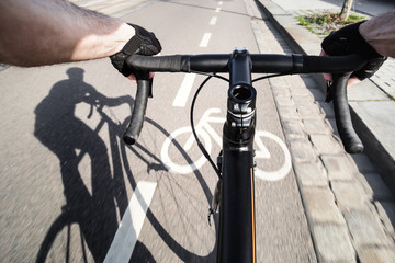 First-person view of cyclist and shadow of cyclist