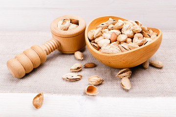 Organic food amonds in wooden bowl. Food mix background, top view, flat lay, copy space, banner.