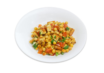 Cooked chickpea with chicken and vegetables on white dish