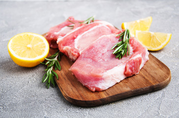 Fresh raw pork chops with spices and herbs
