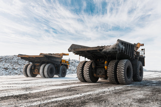 Large quarry dump truck. Loading the rock in dumper. Loading coal into body truck. Production useful minerals. Mining truck mining machinery, to transport coal from open-pit as the Coal Production.