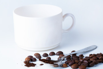 Coffee cup and beans on old kitchen table.