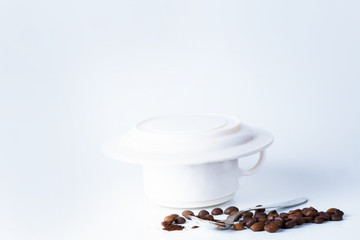 Coffee cup and beans on old kitchen table.