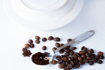 Coffee cup and beans on old kitchen table.