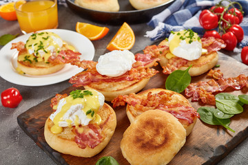 Eggs Benedict on plate and on board