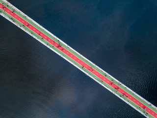Aerial top view of pedestrian and cycling path lane on Park bridge and Dnieper river from above in...