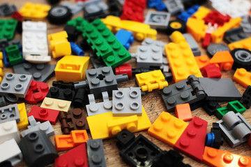 Pile of bright multicolored plastic building blocks