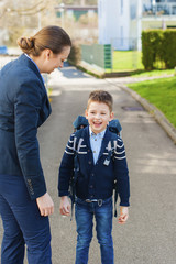 One happy young schoolboy mith mum