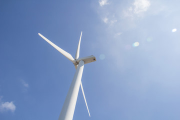 low angle view of wind turbine against partly cloudy blue sky