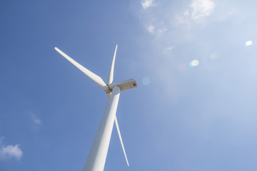 low angle view of wind turbine against partly cloudy blue sky © bumbumbo