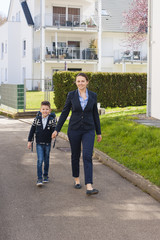 happy mom and boy going to school