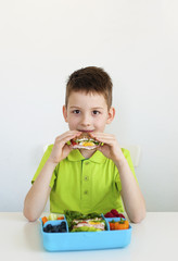 young boy eating healthy food
