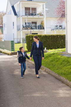 Happy Mother And Son Going To School.