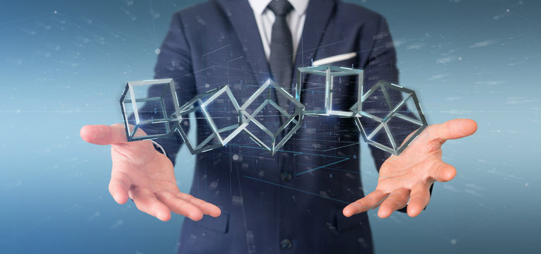 Businessman holding a 3d rendering blockchain cube isolated on a background