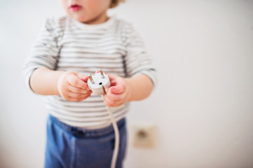 Toddler boy in a dangerous situation at home.