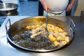 Freshly cooked Sicilian crispelle. Street food typical of Sicily, prepared with flour, ricotta, anchovies and fried.
