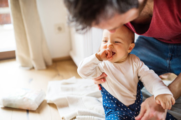 Father with a baby girl at home.