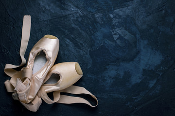 ballet pointe shoes on a dark background.
