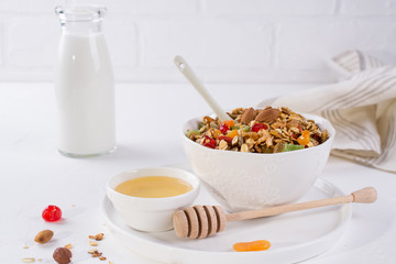 Bowl with homemade granola on white background for healthy breakfast . Healthy snak.