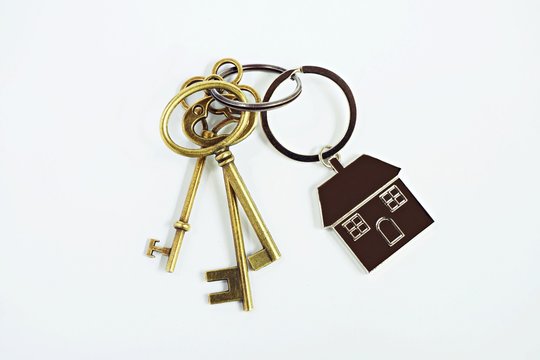 House key with home keyring on white background