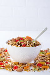 Bowl with homemade granola on white background for healthy breakfast . Healthy snak.