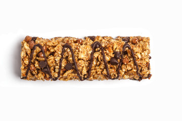 Chocolate granola bar isolated on white background. Healthy sweet dessert snack. Cereal granola bar with nuts, chocolate  and berries on a white background. Top view copy space.
