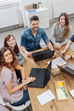 Cheerful co-workers working on project in office