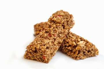 Strawberry granola bars isolated on white background. Healthy sweet dessert snack. Cereal granola bar with nuts and berries