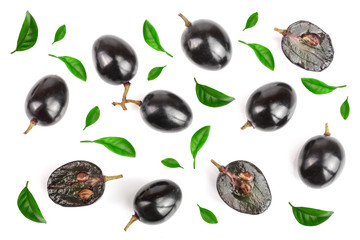 Dark grapes decorated with green leaves isolated on white background, top view. Flat lay