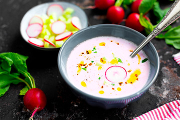 Cold radish and cucumber soup on a rustic background