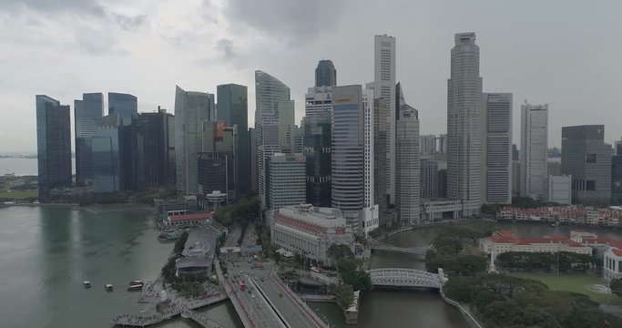 4k aerial footage of Singapore skyscrapers with city skyline during cloudy summer day