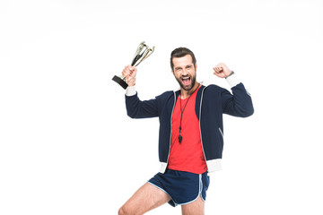 excited sportive trainer yelling and holding award, isolated on white