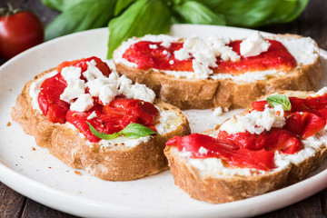 Italian bruschetta with roasted pepper and goat feta cheese. Closeup view, selective focus