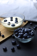 Blueberry yogurt in glass bowl on wooden table