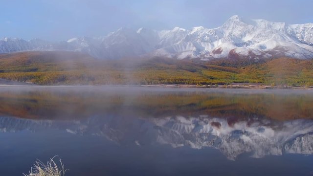 View on Altai lake Dzhangyskol on mountain plateau Eshtykel. North Chui ridge is reflecting in the water