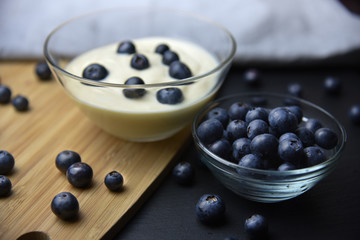 Blueberry yogurt in glass bowl on wooden table