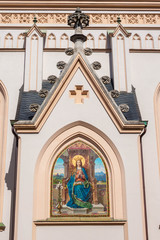 Mosaic depicting Virgin Mary with a book. An exterior detail of St. Nikolaus parish church in Rosenheim, Bavaria, Germany.