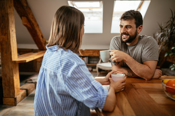 Young happy couple having coffee in the morning