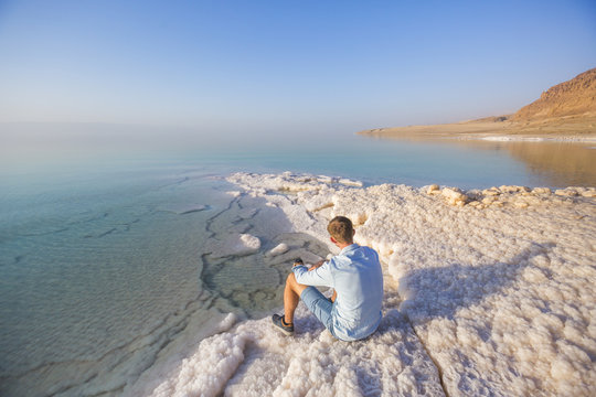 Ttourist on shore of Dead Dea. Jordan landscape